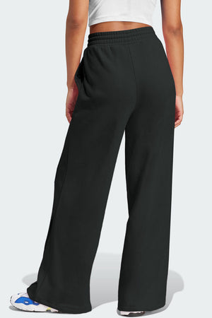 Black seamed wide leg lounge trousers with elastic waistband and flared hem.