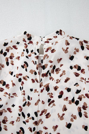 White high-neck blouse with abstract print and button-back detail