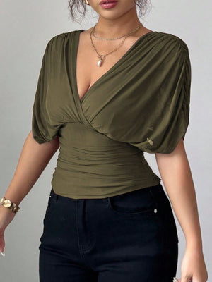 Army green ruched surplice dolman sleeve top with a deep V-neckline.