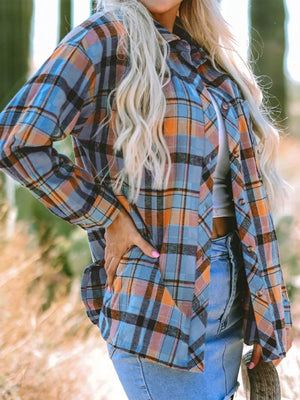 Oversized plaid shacket in sky blue with orange and black plaid, relaxed fit, button front, and chest pockets.