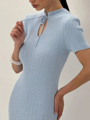 Light blue knitted mermaid dress with tied neckline and short sleeves.