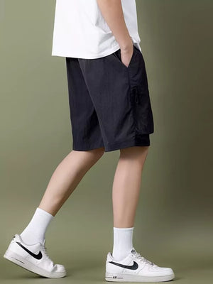Black lightweight cargo shorts with zipper pocket detail and drawstring waist