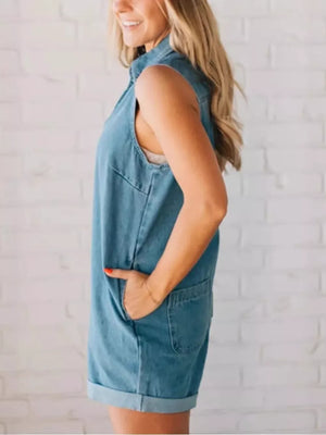 Denim romper with zipper, pockets, and cuffed hem.