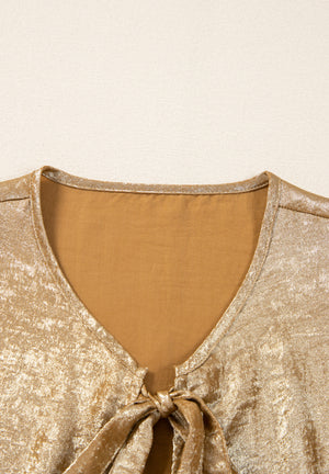Gold Luxe Bow-Front Peplum Blouse with V-neck and tie detail.