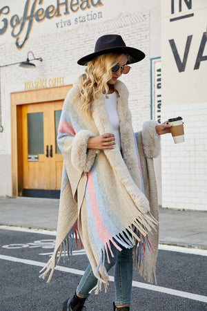 Textured stripe poncho with faux fur trim and fringe, in a neutral multi-color stripe.