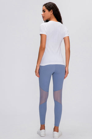 White activewear seamless tee with short sleeves and subtle texture detail.