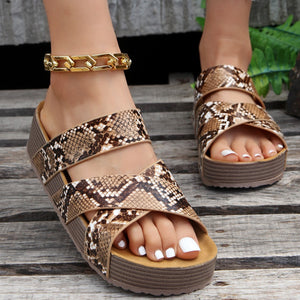 Braided strap platform sandals in snake pattern with a gold chain anklet.