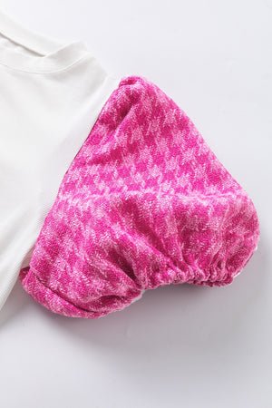 White ribbed knit blouse with pink houndstooth puff sleeves.