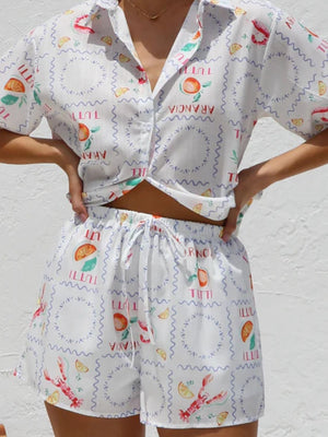 White resort set with citrus and lobster print, button-down shirt and drawstring shorts.