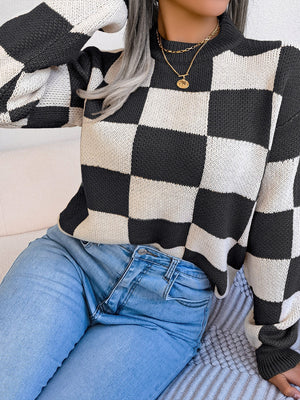 Checkerboard knit mock neck pullover sweater in black and white acrylic with a relaxed fit.