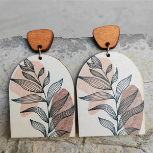 Botanical arch wood earrings in apricot with abstract leaf print and wooden top detail.