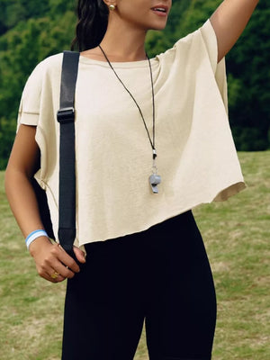 Apricot t-shirt with exposed seams and cutout back detail.