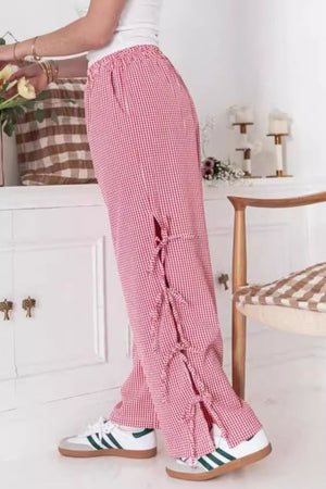 Gingham palazzo trousers in scarlet with side tie details and a wide leg.