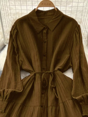Textured tiered long sleeve dress in Olive Brown with button-down front and tie belt.