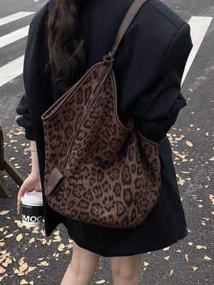 Chic leopard print tote bag in brown with leather trim and strap.