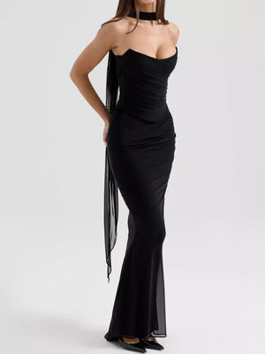 Black sweetheart tube top dress with ruched bodice and flowing maxi skirt.