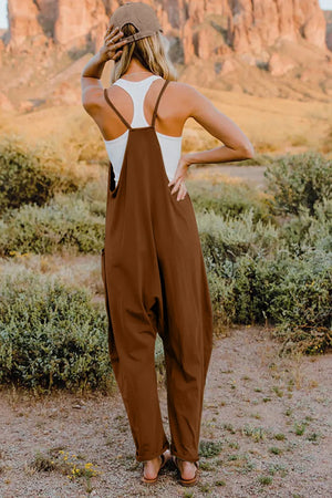 Coffee brown cotton jumpsuit with wide legs and pockets, worn with a white tank top.