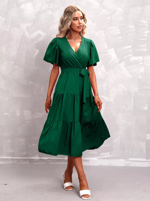 Dark green flutter sleeve tiered midi dress with wrap neckline and tie belt.