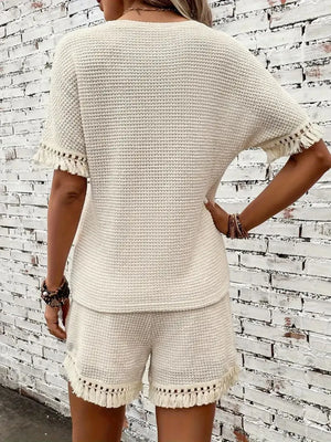Cream textured knit set with fringe detail on short sleeves and shorts.