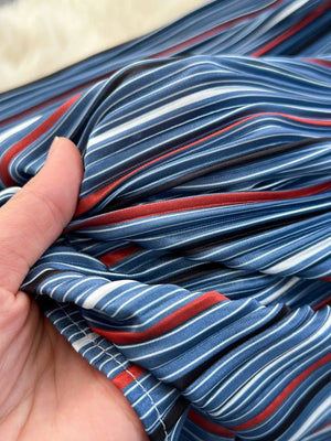 Patchwork denim midi skirt with red and white stripes, buttoned detail.