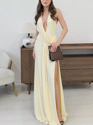 Yellow ruched halter neck maxi dress with a deep V-neck and high slit.