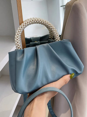 Blue ruched crossbody bag with pearl handle and shoulder strap