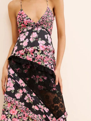 Maxi dress with floral print, black lace trim, and asymmetrical hem.