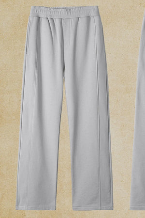 Gray seamed lounge trousers with elastic waist and pockets.
