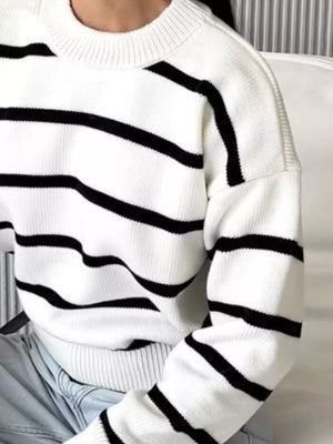 Classic striped knit sweater with round neck in white with black stripes.
