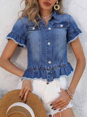 Blue denim trucker jacket with ruffled hem, pearl buttons, and short sleeves.