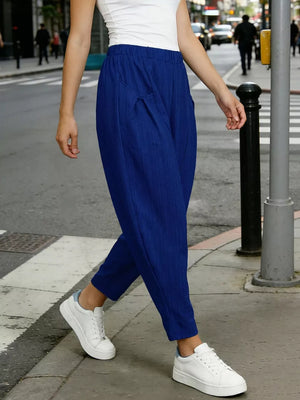 Royal blue harem pants with pockets and elastic waist, styled with white sneakers.