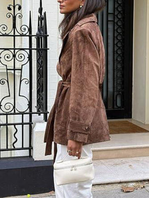 Dark brown belted trench coat with cuffed sleeves and button details.
