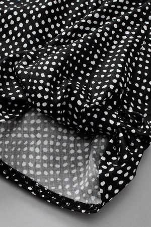 Black dotted puff sleeve blouse with tie detail.