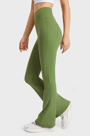 Green flare yoga pants with high waist and stitched details.