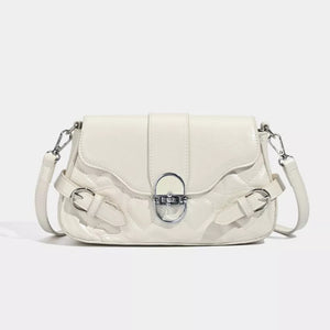 White heart-quilted crossbody bag with buckle accents and silver hardware