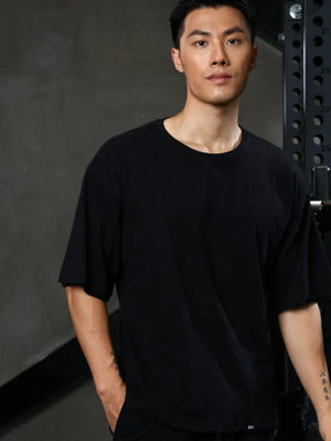 Black oversized tee with raw edges and distressed details.