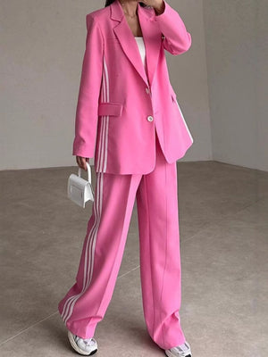 Hot Pink pant suit with white track stripes on blazer and pants.
