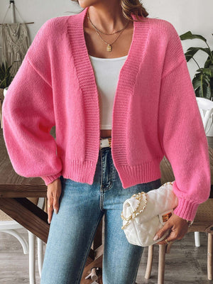 Balloon sleeve knit cardigan in strawberry pink with ribbed cuffs and open front.