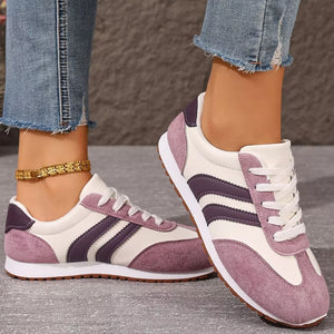 Two-tone suede lace-up sneakers in pink purple with white laces and soles.