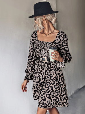 Smocked bodice leopard print mini dress with square neckline and tiered skirt.