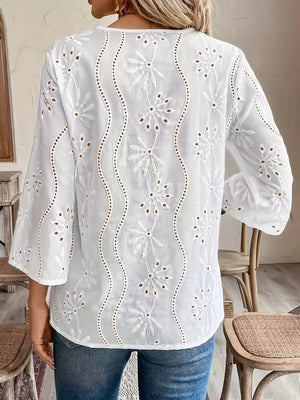 White blouse featuring lace detail and eyelet