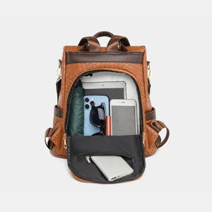 Brown woven faux leather convertible backpack with open main compartment showing tablet, phone, sunglasses, and lipstick.