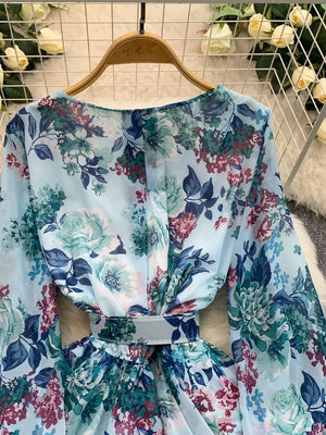 Light blue floral ruffle hem wrap mini dress with cinched waist and long sleeves.