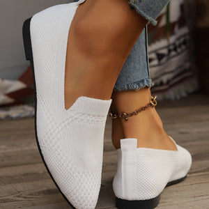 White breathable pointed-toe flats with a knit texture and elastic heel detail.