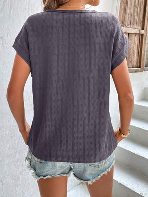 Woven texture cap-sleeve top in dark gray with a relaxed fit, styled with denim shorts.