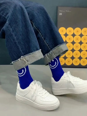 White minimalist platform sneakers with lace-up closure and perforated toe box.