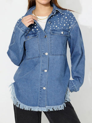 Medium wash denim shirt with pearl embellishments and frayed hem.