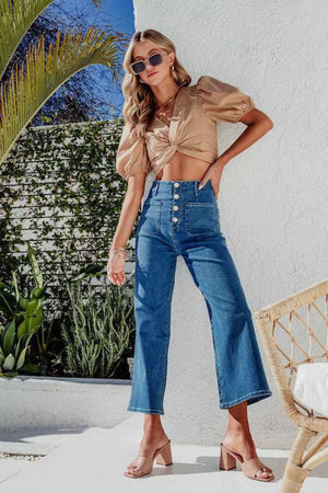 Button-front cropped wide-leg jeans in light blue denim with a high waist and four-button closure.