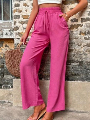 Drawstring linen palazzo trousers in cerise with a relaxed fit and button detail pockets.