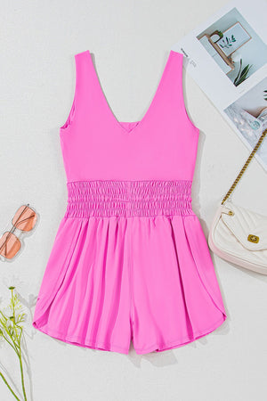 Fuchsia pink active romper with scoop neck and smocked waist.